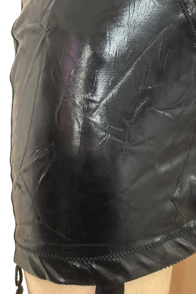 Detail view of 2000s vintage goth pin-up black wet look nylon Lycra stretch lingerie garter skirt by Bernie Dexter, size medium to large. Showing a close-up of the elastic at the bottom edge.