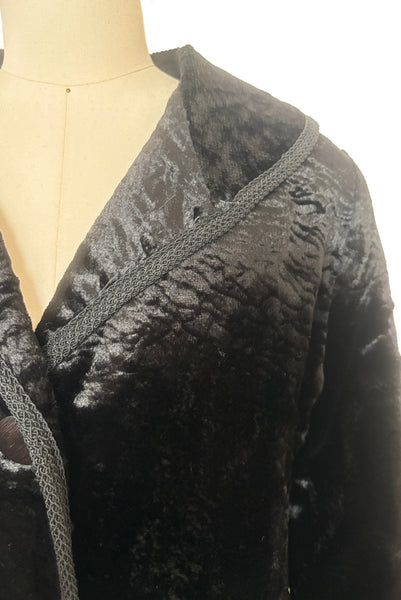 Detail view of 1950s vintage black faux Persian lamb embossed velvet jacket, by Specialty House Fashion, size small to medium. Showing the collar with braid along the edge.