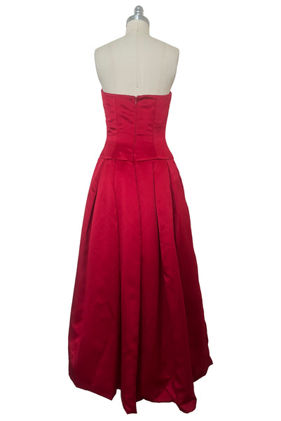 Back view of 1990s strapless sweetheart pleated bodice full pleated red peau de soie satin evening gown by AJ Bari, size extra small to small.