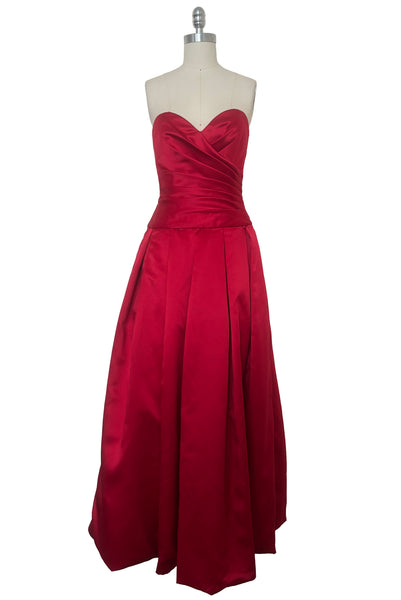 Front view of 1990s strapless sweetheart pleated bodice full pleated red peau de soie satin evening gown by AJ Bari, size extra small to small.