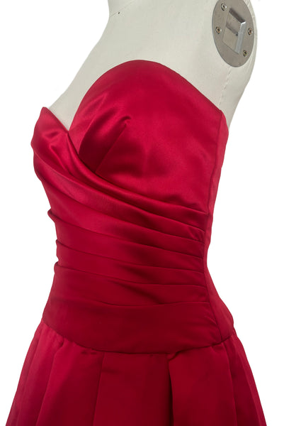Bodice 3/4 view of 1990s strapless sweetheart pleated bodice full pleated red peau de soie satin evening gown by AJ Bari, size extra small to small. Showing a close-up of the pleated, wrapped bodice.