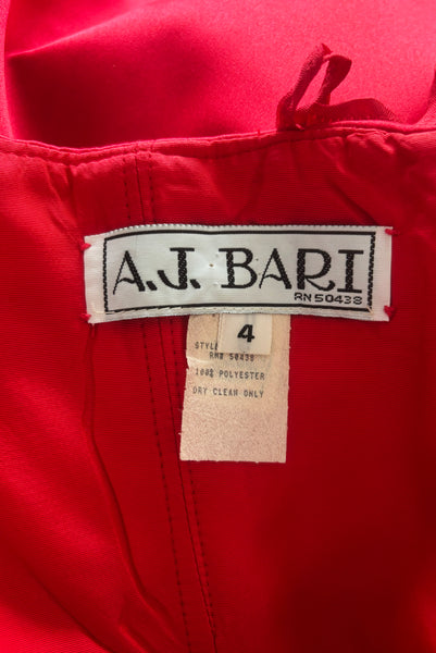Interior detail view of 1990s strapless sweetheart pleated bodice full pleated red peau de soie satin evening gown by AJ Bari, size extra small to small. Showing the A.J. Bari label and size 4 tag.