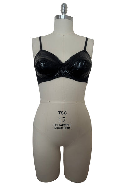 Front view of 2000s vintage y2k goth pin-up lingerie black nylon Lycra wet look bra by Bernie Dexter for Lucy B, size medium to large.