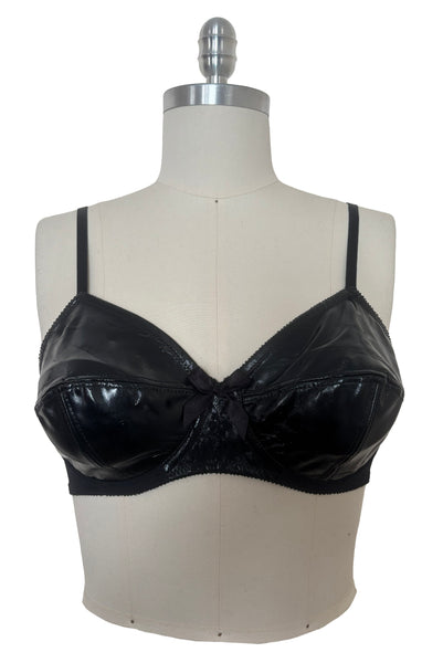 Front view of 2000s vintage y2k goth pin-up lingerie black nylon Lycra wet look bra by Bernie Dexter for Lucy B, size medium to large.