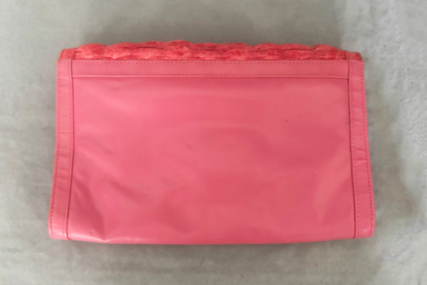 Horizontal back view of 1980s vintage pink snakeskin and leather clutch purse with detachable strap by Impo.