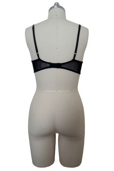 Back view of 2000s vintage y2k goth pin-up lingerie black nylon Lycra wet look bra by Bernie Dexter for Lucy B, size medium to large.