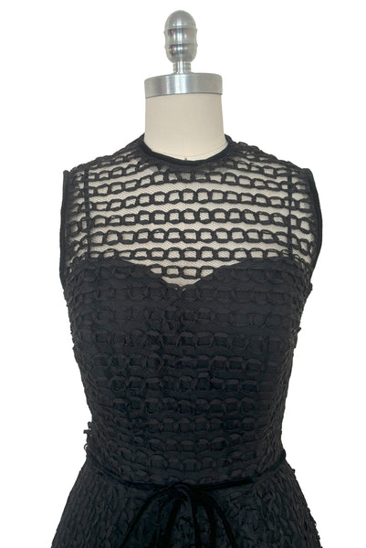 Bodice front view of 1950s vintage sleeveless New Look style black tulle silk ribbon dress by Dance Time, size extra small to small. Showing the black velvet piping at the neck & sleeves, and the built in sweetheart neckline slip.