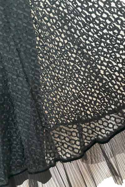 Detail view of 1950s vintage sleeveless New Look style black tulle silk ribbon dress by Dance Time, size extra small to small. Showing the black velvet piping, and pleated net hem.