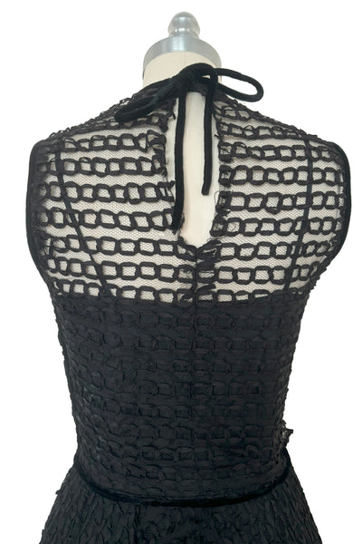 Bodice back view of 1950s vintage sleeveless New Look style black tulle silk ribbon dress by Dance Time, size extra small to small. Showing the black velvet piping at the armholes and tie neck.
