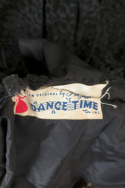 Interior detail view of 1950s vintage sleeveless New Look style black tulle silk ribbon dress by Dance Time, size extra small to small. Showing the Dance Time label.