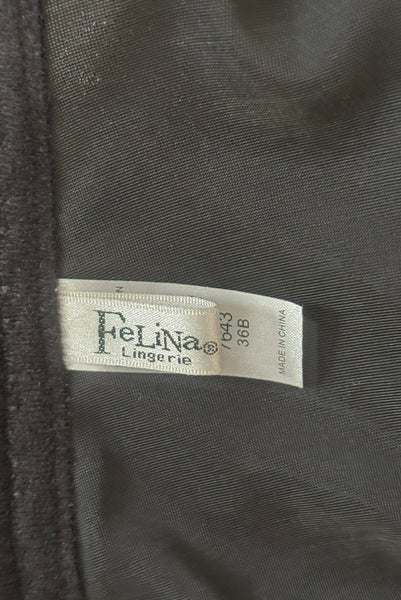 Detail view of 2000s y2k vintage deadstock new with tags black seamless underwire strapless longline bra by Felina, size 36B. Showing the Felina label.