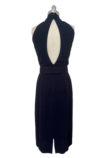 Back view of 1990s vintage navy blue crepe V-neck, keyhole back dress with draped skirt and belt by BB Collections, medium to large.