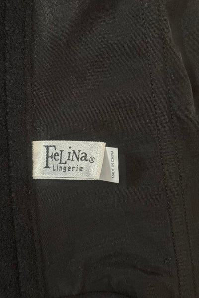 Detail view of 2000s y2k vintage deadstock new with tags black seamless underwire strapless longline bra by Felina, size 32C. Showing the Felina label.