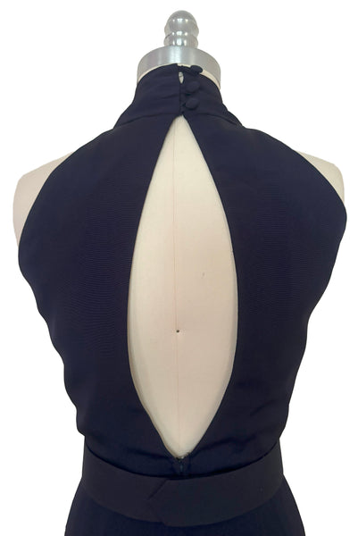 Bodice back view of 1990s vintage navy blue crepe V-neck, keyhole back dress with draped skirt and belt by BB Collections, medium to large. Showing the open back and the three button closure at the neck.