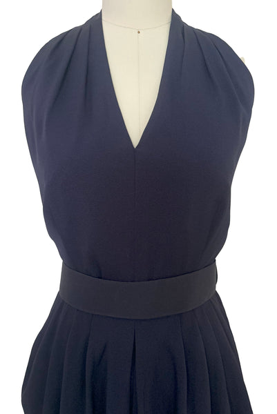 Bodice front detail view of 1990s vintage navy blue crepe V-neck, keyhole back dress with draped skirt and belt by BB Collections, medium to large. Showing the V-neck halter neckline, and belt.