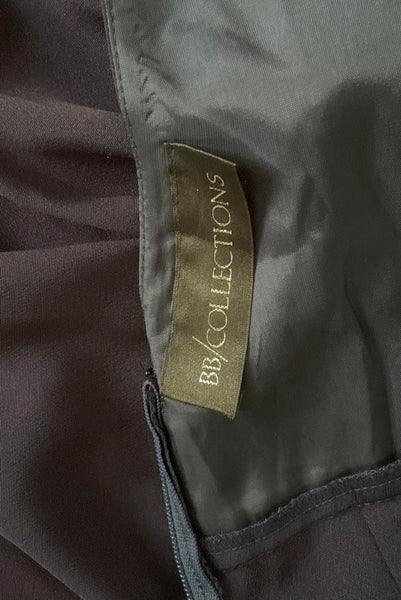 Interior detail view of 1990s vintage navy blue crepe V-neck, keyhole back dress with draped skirt and belt by BB Collections, medium to large. Showing the BB Collections label.