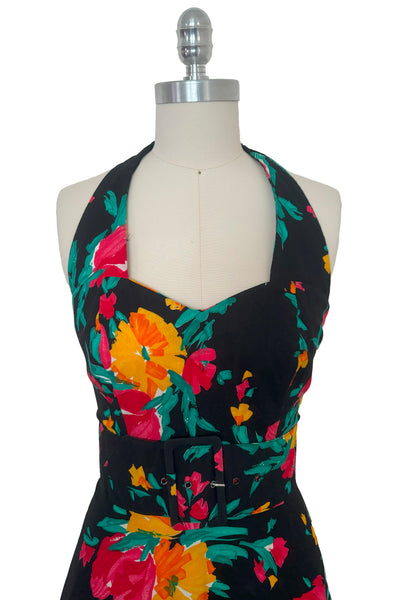 Bodice front view of vintage 1990s black, pink, green, and yellow floral halter dress with matching belt by Concepts, extra small to small.