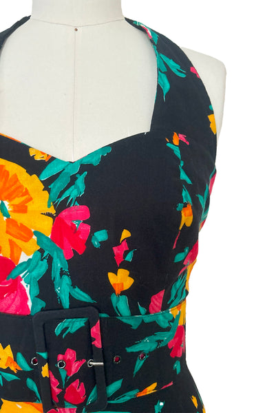 Bodice detail view of vintage 1990s black, pink, green, and yellow floral halter dress with matching belt by Concepts, extra small to small.