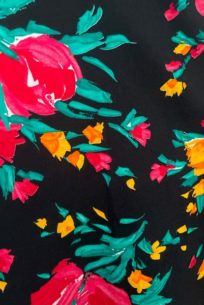 Fabric detail of vintage 1990s black, pink, green, and yellow floral halter dress with matching belt by Concepts, extra small to small.