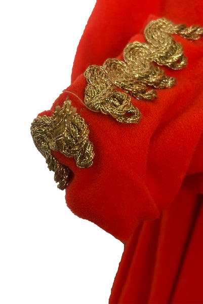Detail view of 1960s  vintage orange fleece zip front housecoat w/ gold metallic braid by Periphery, size medium to large. Showing the gold trim unraveling on one of the cuffs.