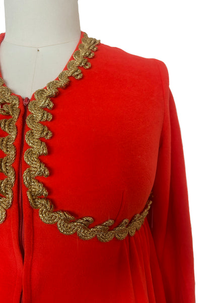 Detail view of 1960s  vintage orange fleece zip front housecoat w/ gold metallic braid by Periphery, size medium to large. Showing the curved empire waist and gold bullion trim.