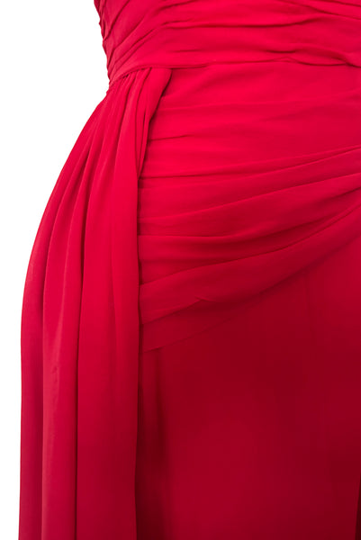 Detail view of 1960s vintage draped raspberry pink silk chiffon cocktail dress by Miss Bonwit, size extra small to small. Showing the draped bodice, hip swag, and gathered overskirt.