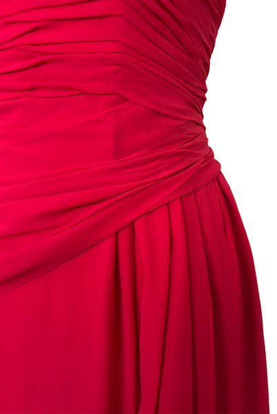 Detail view of 1960s vintage draped raspberry pink silk chiffon cocktail dress by Miss Bonwit, size extra small to small. Showing the draped bodice, hip swag, and gathered overskirt.