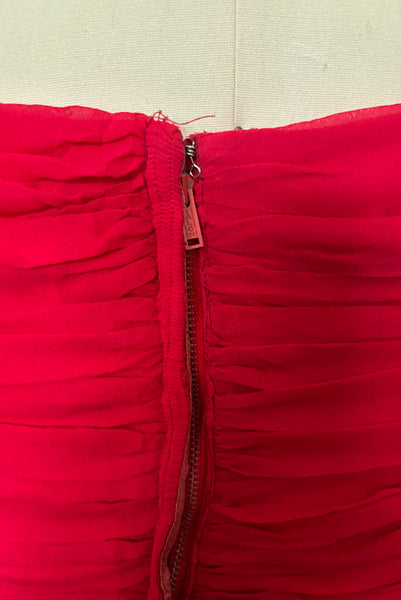 Detail view of 1960s vintage draped raspberry pink silk chiffon cocktail dress by Miss Bonwit, size extra small to small. Showing the metal zipper.