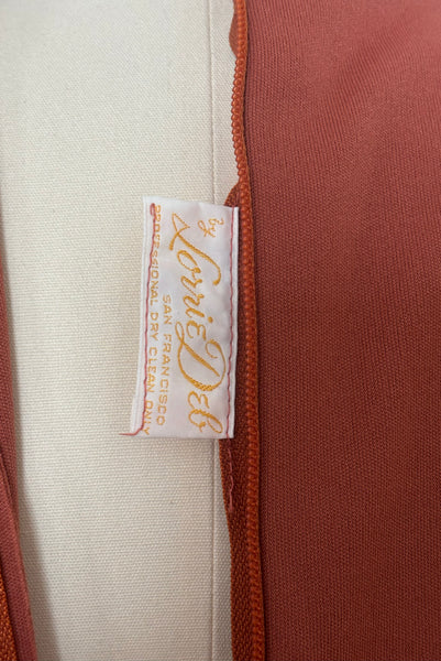 Interior detail view of 1970s vintage new with out tags terra cotta brown high neck knit maxi bridesmaids dress by Lorrie Deb, size small to medium. Showing the Lorrie Deb label.