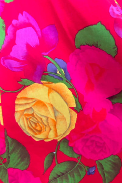 Fabric detail view of 1990s vintage red, pink, yellow, green, and purple floral strapless dress by AJ Bari, size small to medium. Showing the vibrant print.