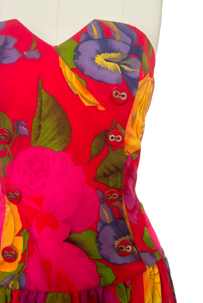 Bodice detail view of 1990s vintage red, pink, yellow, green, and purple floral strapless dress by AJ Bari, size small to medium. Showing the faux double-breasted front with red and gold plastic buttons.