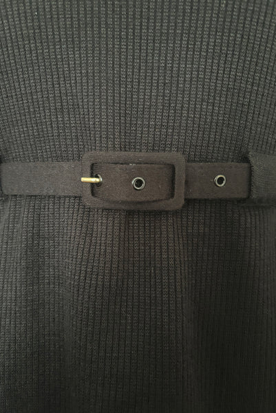 Detail view of 1990s black mockneck wool blend sweater dress with peplum by Liz Claiborne, medium to large. Showing the ribbed knitted bodice with built in belt carriers and matching belt.