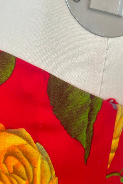 Bodice detail view of 1990s vintage red, pink, yellow, green, and purple floral strapless dress by AJ Bari, size small to medium. Showing some small spots at the underarm.