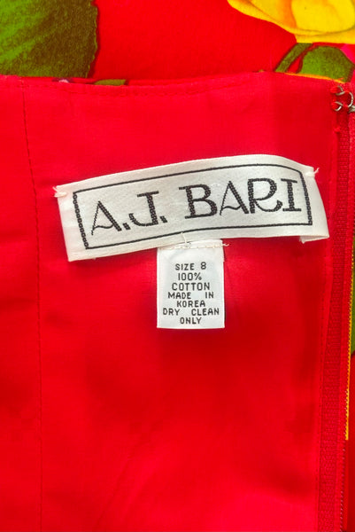 Interior detail view of 1990s vintage red, pink, yellow, green, and purple floral strapless dress by AJ Bari, size small to medium. Showing the A.J. Bari label, the size 8, and 100% cotton tag.