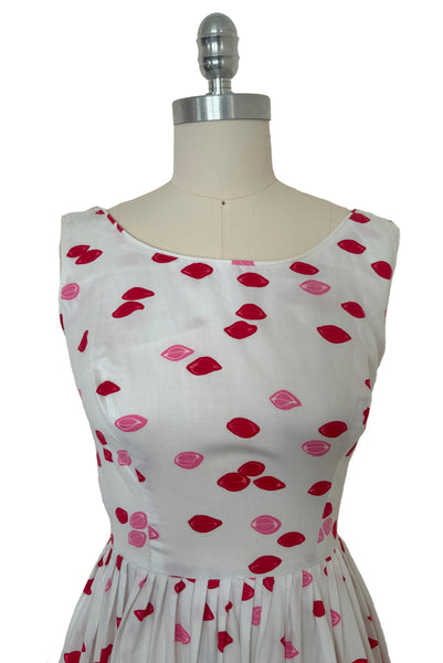Bodice front view of 1950s vintage red and pink lips novelty border print white cotton sleeveless, full gathered skirt dress, size extra small to small.