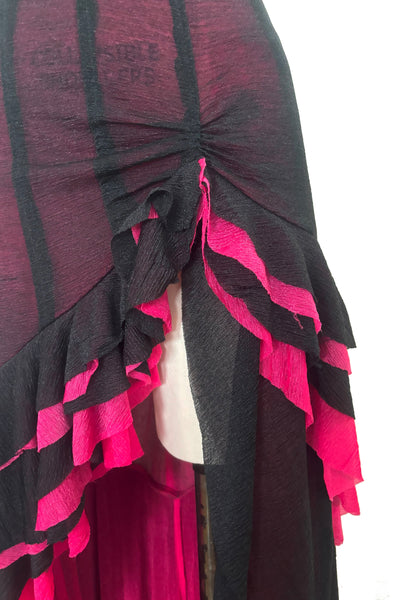 Detail view of 2000s vintage hot pink & black ruffled mesh dance dress costume, size small to medium. Showing the ruffled hem gathered over one hip.