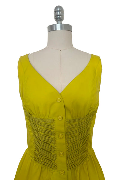 Bodice front view of 1990s vintage chartreuse cotton snap front dress with lacing details by designer Thierry Mugler, size extra small to small.