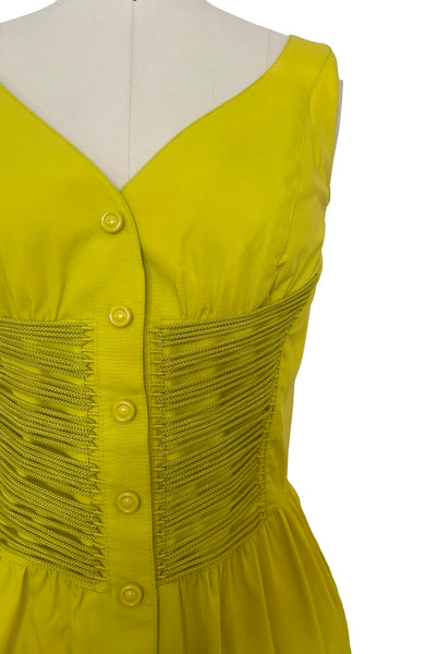 Bodice front view of 1990s vintage chartreuse cotton snap front dress with lacing details by designer Thierry Mugler, size extra small to small. Showing the lacing details.