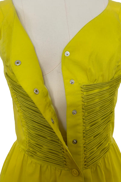 Bodice front view of 1990s vintage chartreuse cotton snap front dress with lacing details by designer Thierry Mugler, size extra small to small. Showing the snap front closure, and lacing details.
