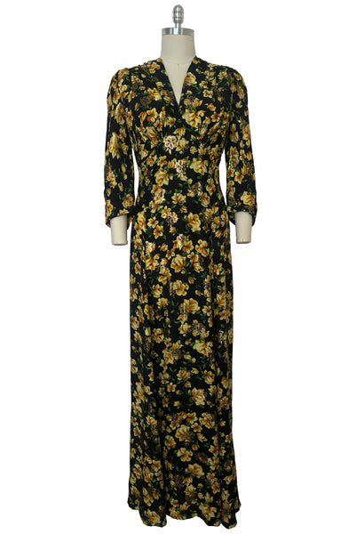 Front view of vintage 2000s made 1940s reproduction black, yellow, and gold floral silk and lurex evening dress, size medium to large.