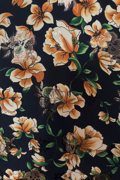 Detail view of vintage 2000s made 1940s reproduction black, yellow, and gold floral silk and lurex evening dress, size medium to large. Showing a close up of the black, yellow and green floral printed silk fabric with floral gold lurex over weave.
