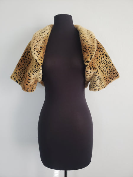 The Leslie Courreges Anita Bolero features recessed leopard spots against golden faux fur.