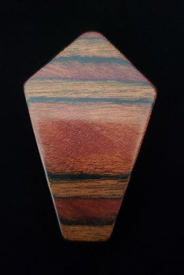 Vertical front view of 1950s vintage brown striped multi-grain kite shaped wood brooch.