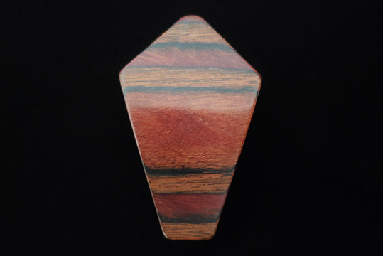 Horizontal front view of 1950s vintage brown striped multi-grain kite shaped wood brooch.