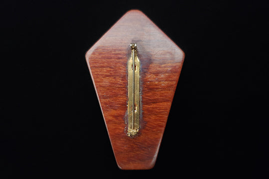 Horizontal back view of 1950s vintage brown striped multi-grain kite shaped wood brooch.