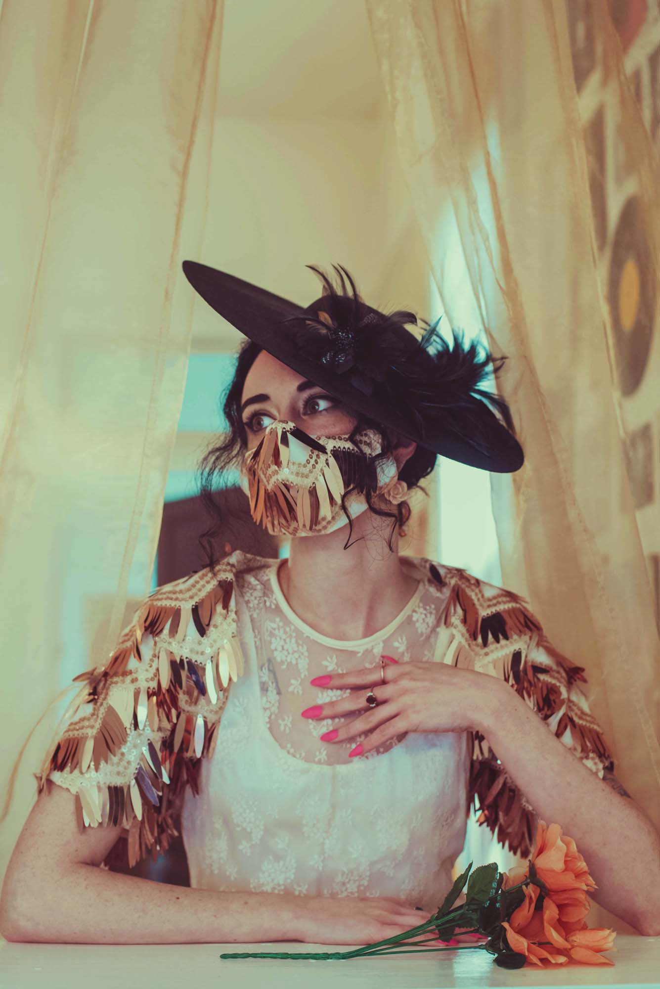 The Leslie Courreges Eleanor Mask features gold sequins against blush embroidery with rose gold fringe sequins.