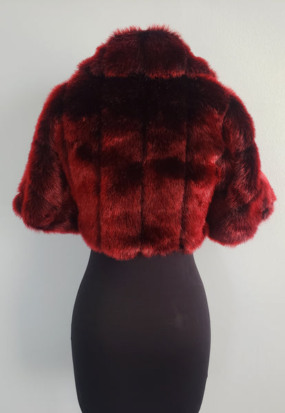 The Leslie Courreges Anita Bolero features deep inky black faux mink with crimson red tips.