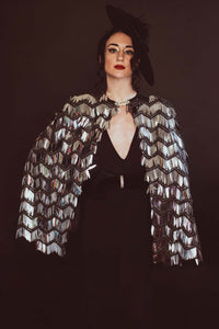 The Leslie Courreges Eleanor Cape features black sequins against complementary embroidery with silver fringe sequins.